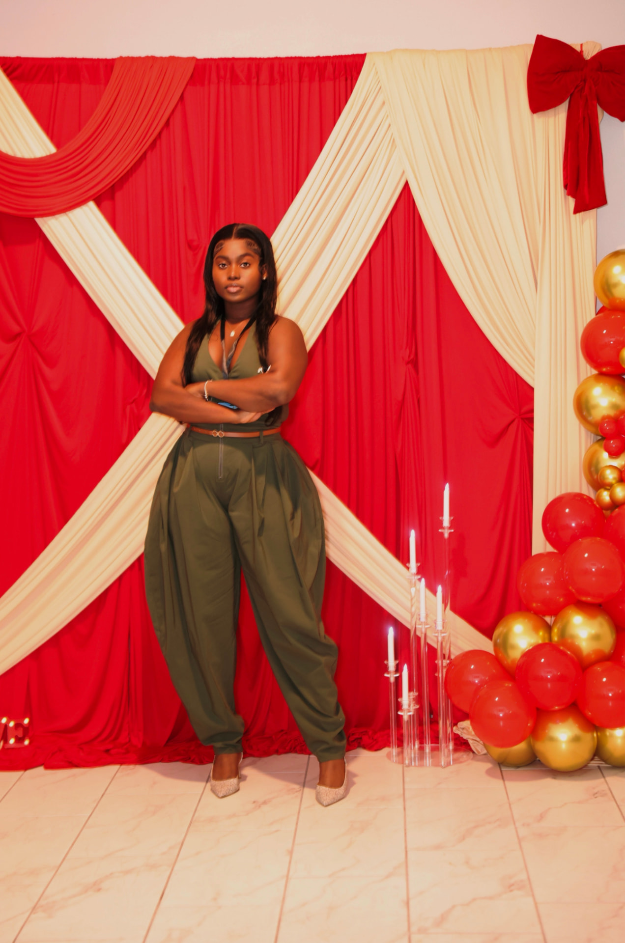 Daloulou Decor — red and cream draped backdrop with red and gold balloon garland